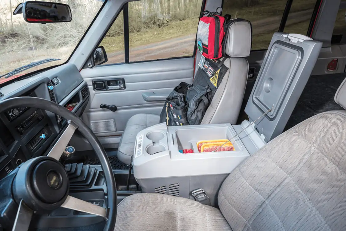 A Dometic 10.5-quart fridge/freezer is installed between the front seats