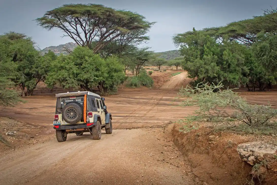 Jeep traveling through dry riverbed