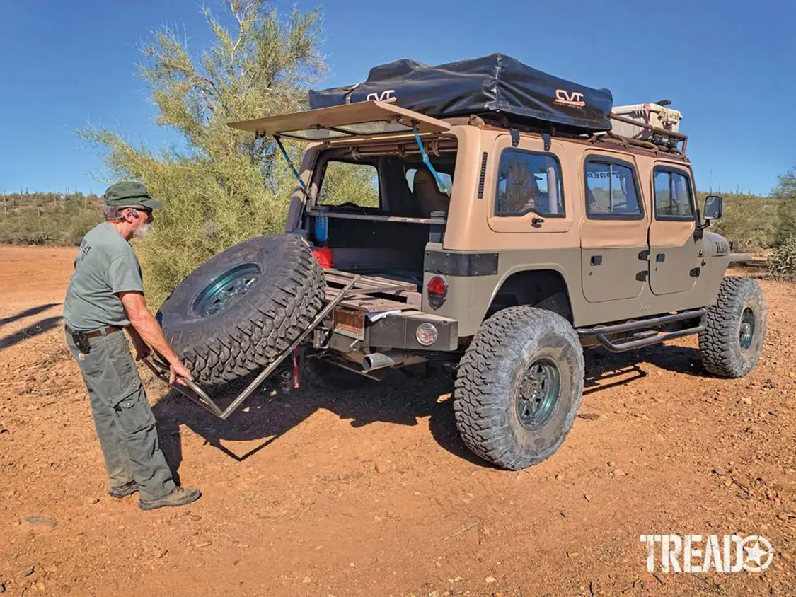 Tetreau easily maneuvers the spare tire in and out of the back of the J1