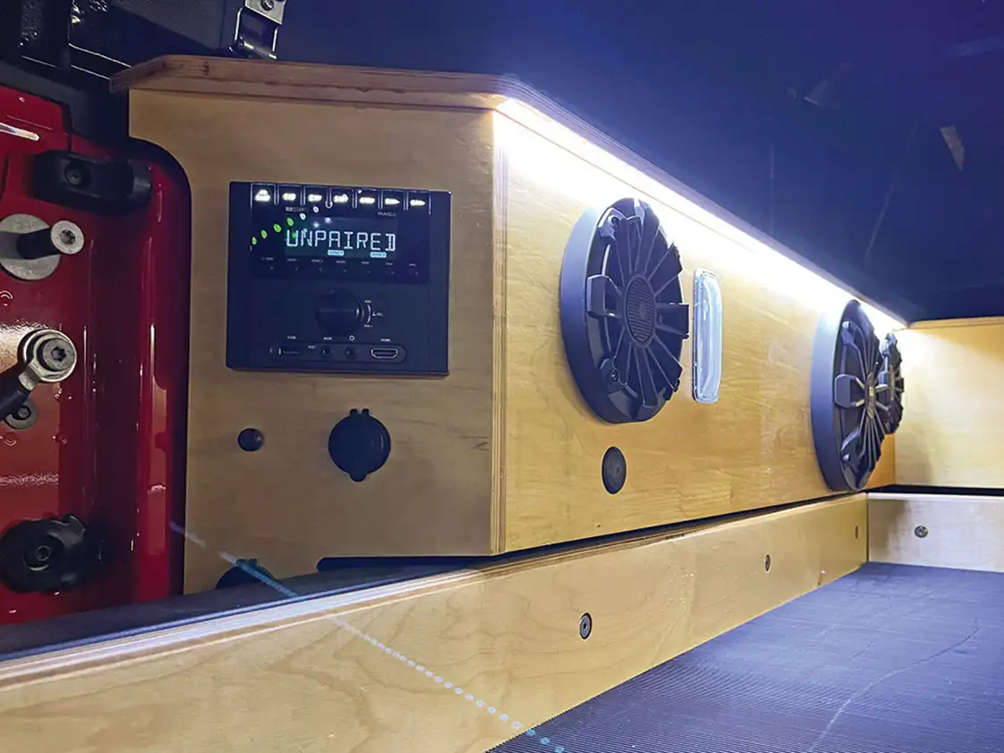 Custom birch cabinet that surrounds the bed of the Jeep