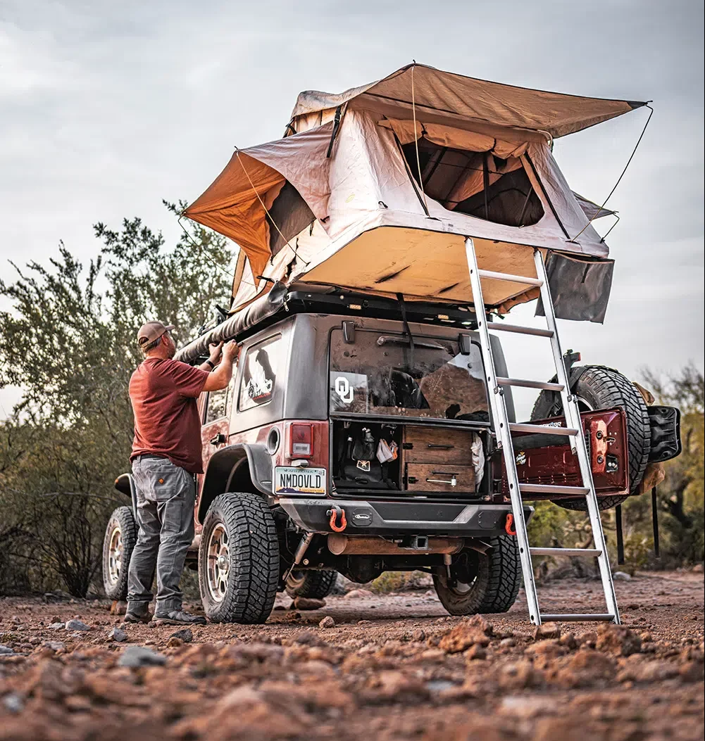 Unrolling the awning at camp